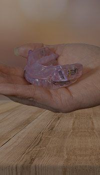 Hand holding oral appliance for sleep apnea treatment