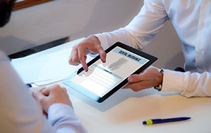 Patient looking at dental insurance form on tablet