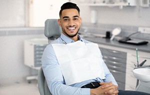 Patient smiling while sitting in treatment chair