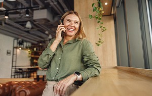 Woman smiling while talking on phone