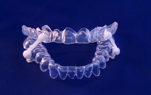 Oral appliance for sleep apnea with blue background 
