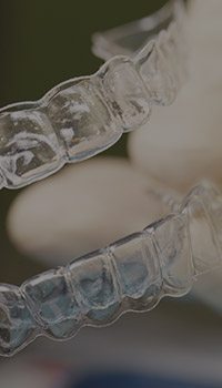 CLose up of two Invisalign clear aligners