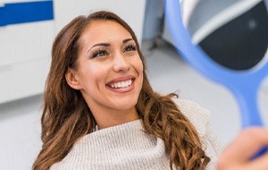 Woman smiling at reflection in mirror