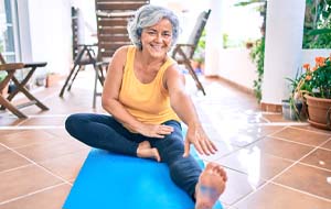 older woman exercising after getting dental implants in Lincoln