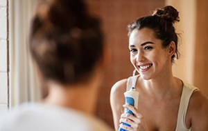 Patient in Lincoln flossing their dental implants