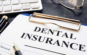 dental insurance form on a blue clipboard