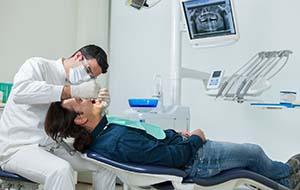 dentist examining a patient’s mouth