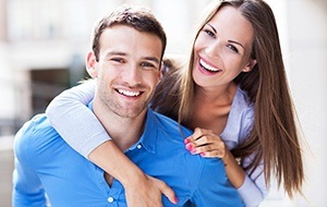A young couple smiling and hugging