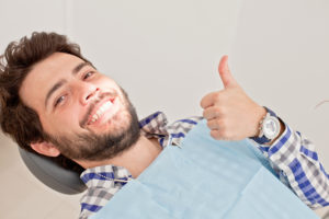 man in dentist chair thumbs up