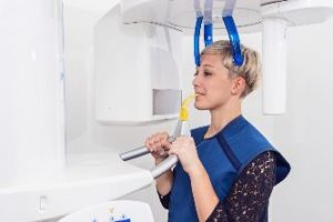 Woman having dental image taken