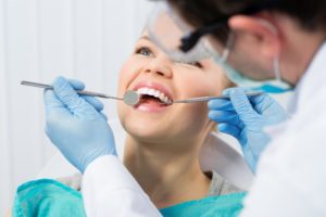 person getting their teeth cleaned by a dentist