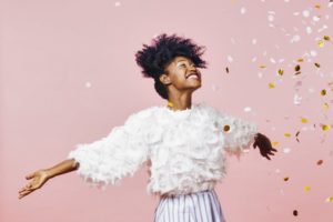 Smiling woman throwing glitter