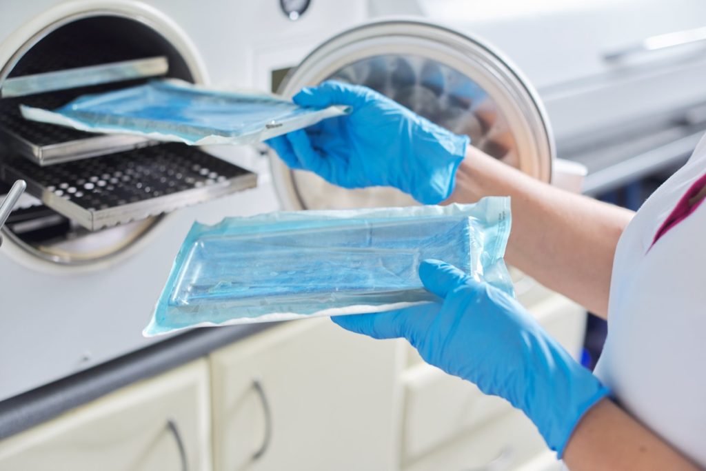 Dentist in Lincoln sterilizes instruments.