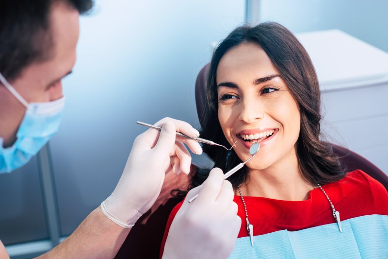 woman smiling at dentist’s office 