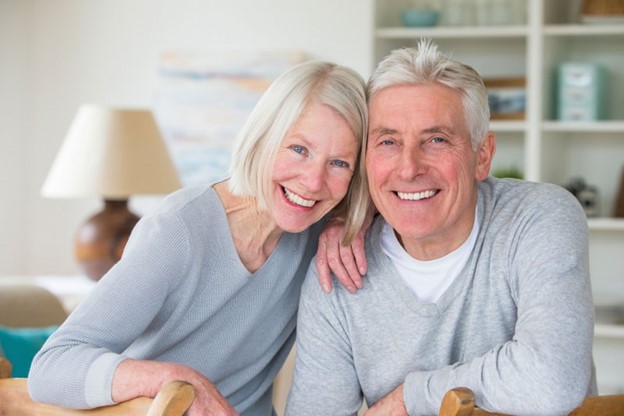 Older couple smiling after recovering from All-on-4 surgery.