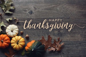 “Happy Thanksgiving” message with pumpkins and leaves