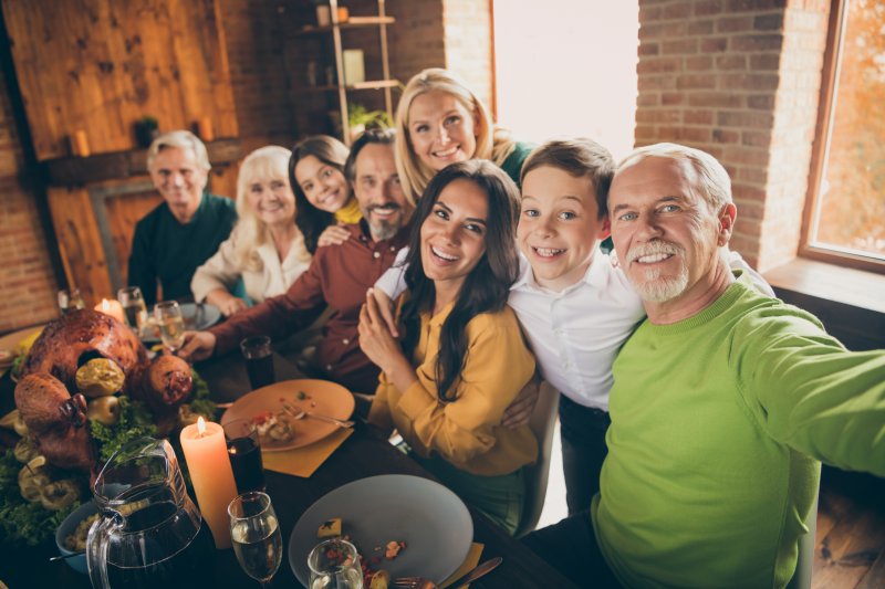 A family enjoying Thanksgiving Dinner with good oral health