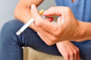 Man holding a cigarette.