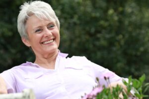 Happy senior woman sitting outside